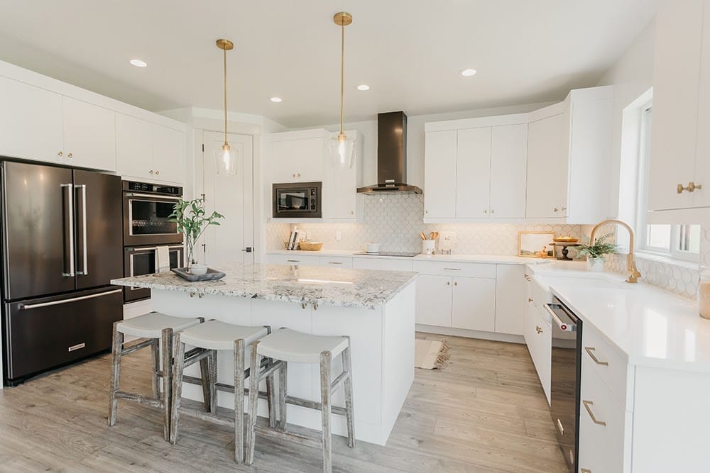 A customized kitchen with island and hardwood floors.