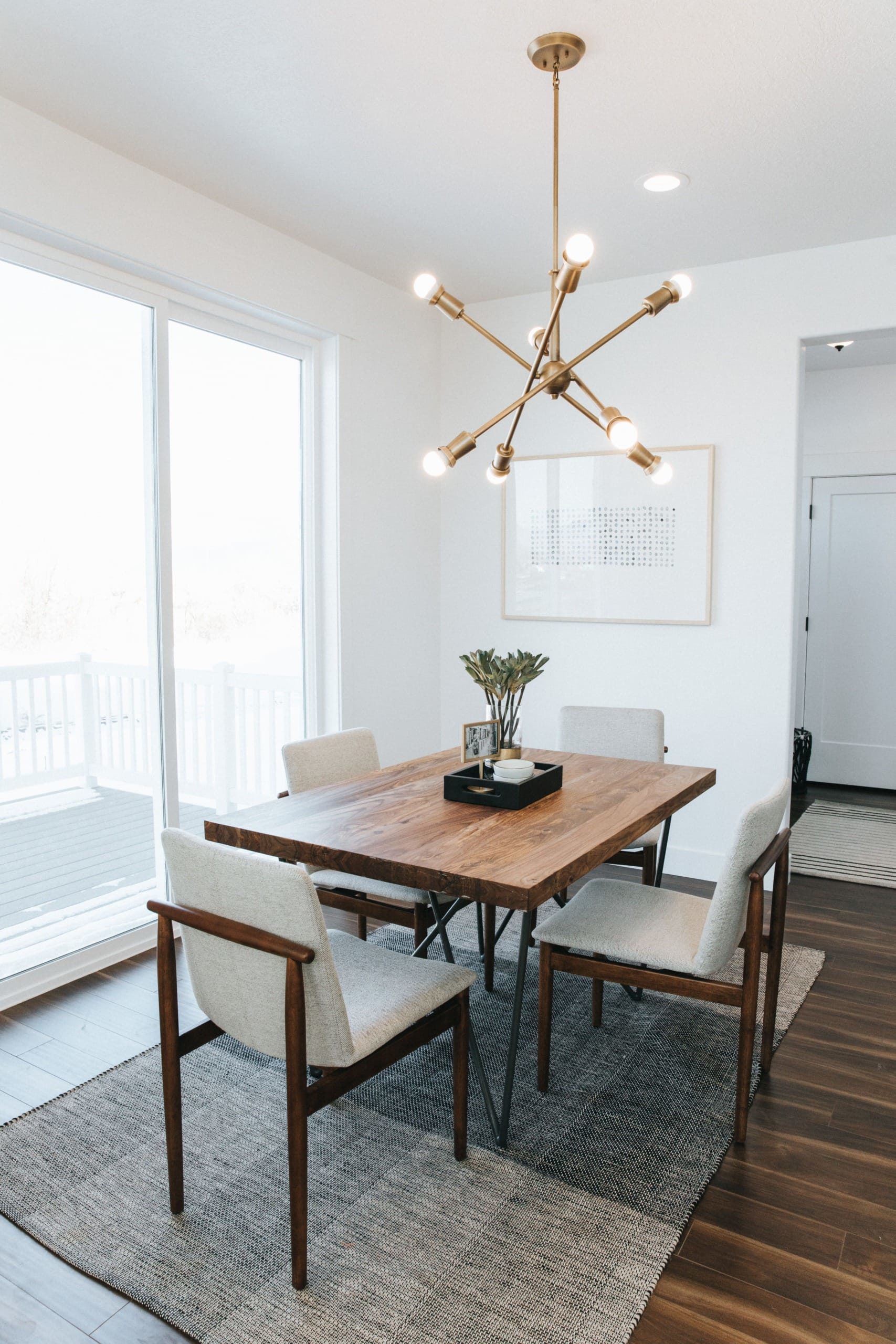 EDGEhomes dining area with table, chairs, and luxury lighting