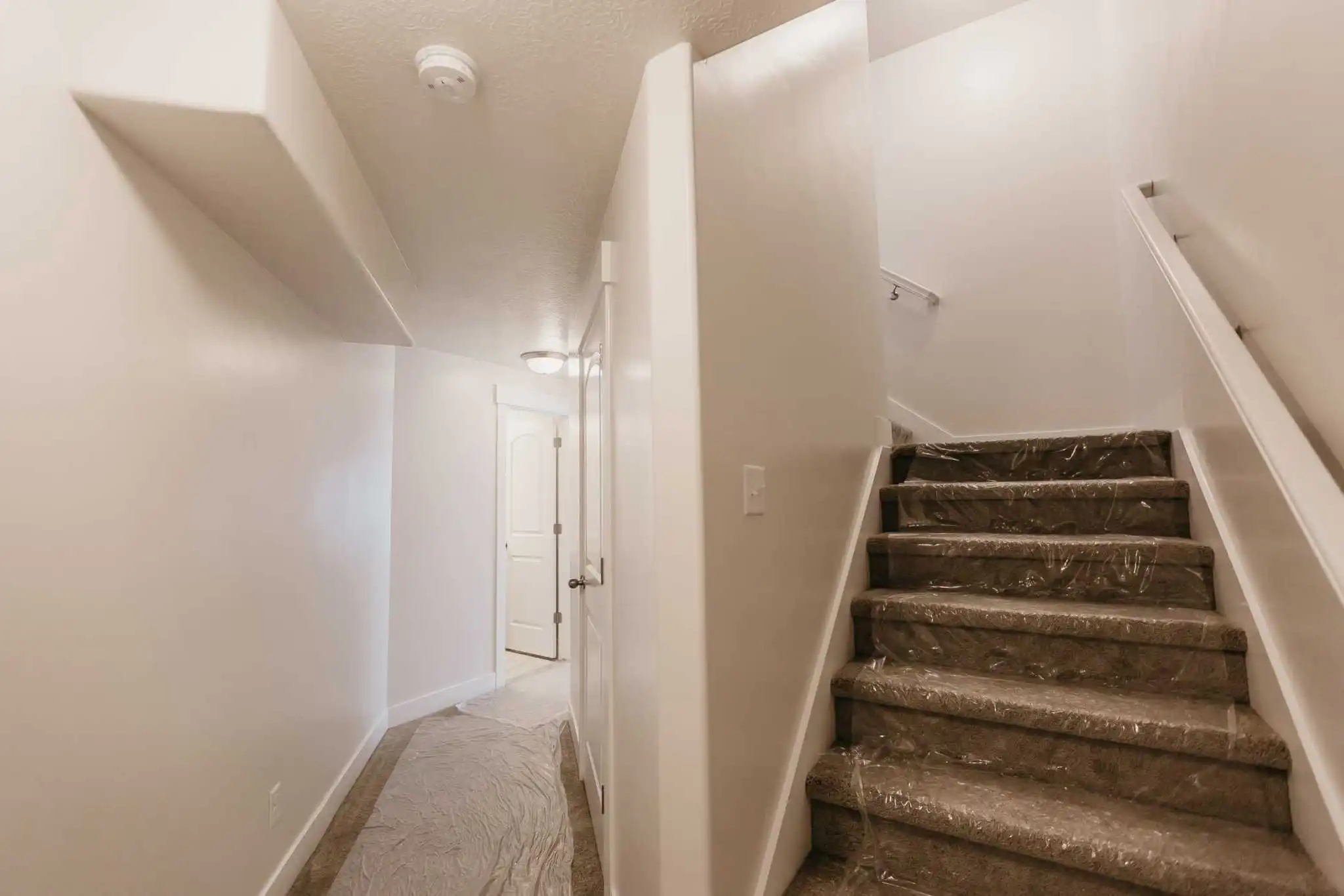 View of stairs and hallway in a finished basement