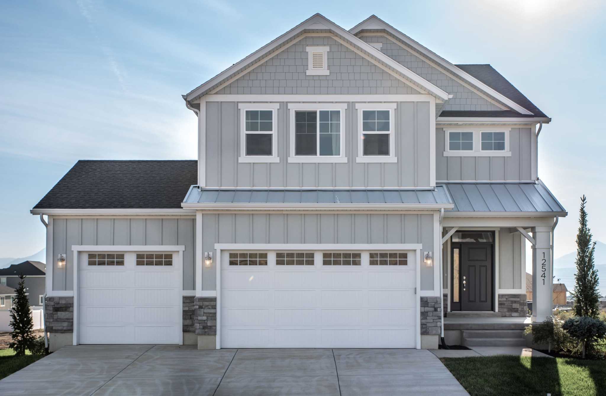 two-story gray single family home with 3-car garage