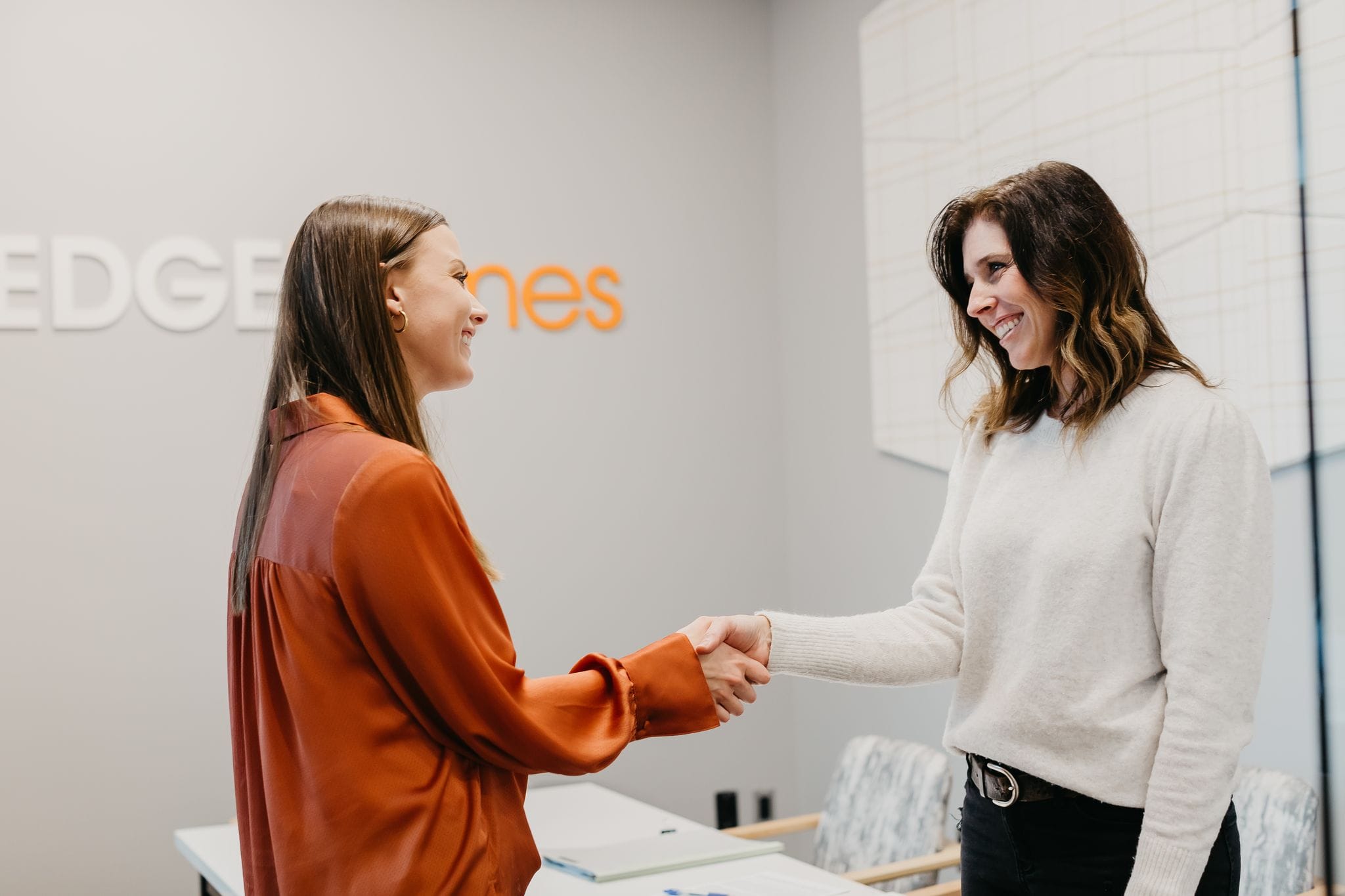 EDGEhomes agent shaking hands with a young woman