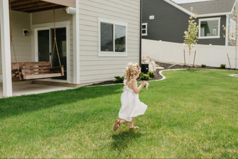 little girl running in the backyard