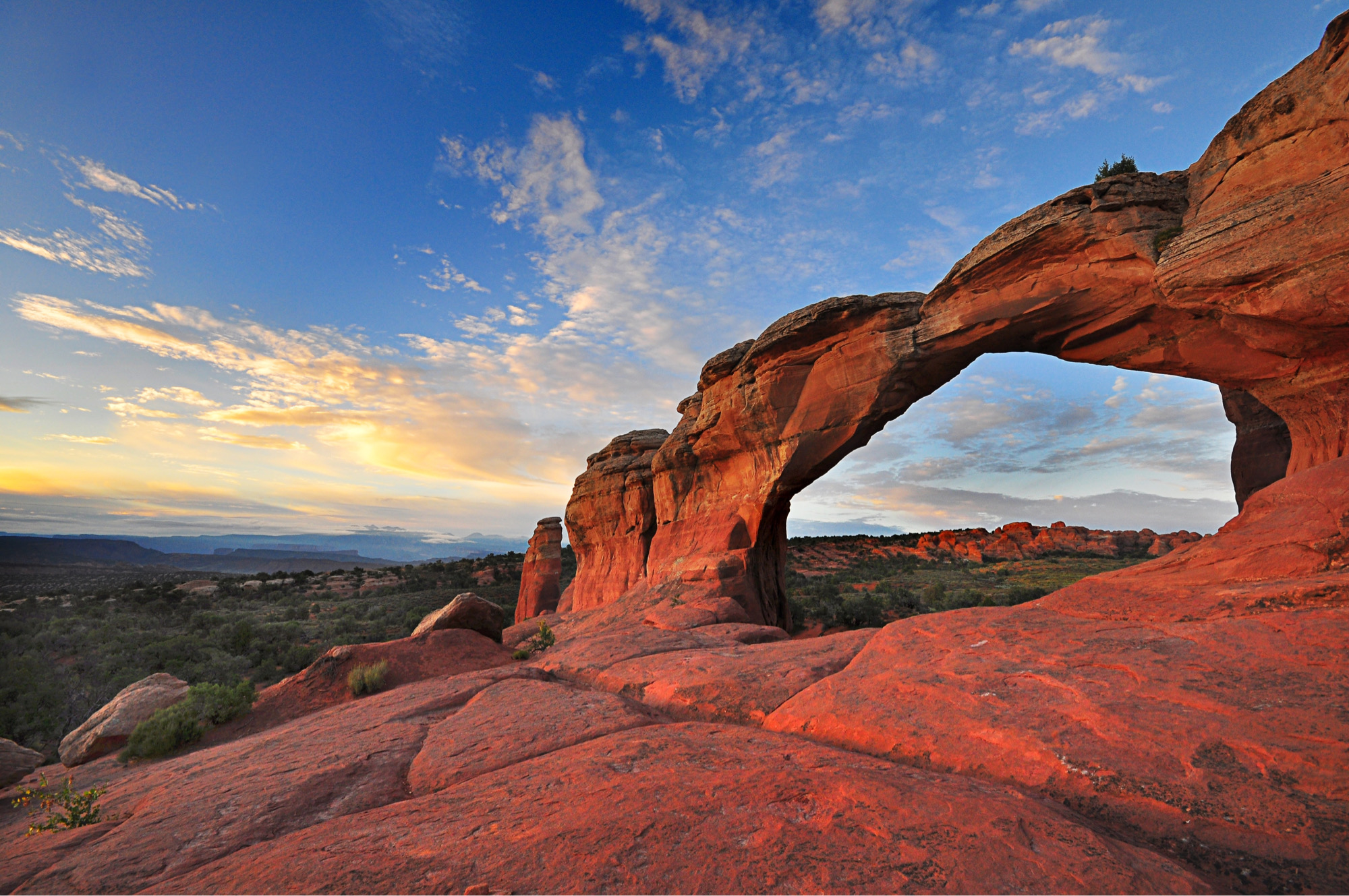 Sunset view of one of many red-rock arches at Arches National Park
