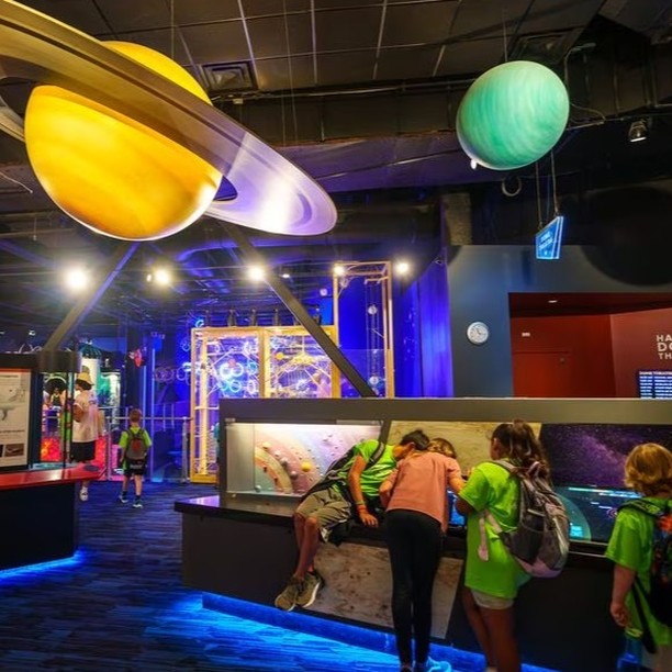 Children playing with the interactive exhibits at Clark Planetarium, a museum in Utah