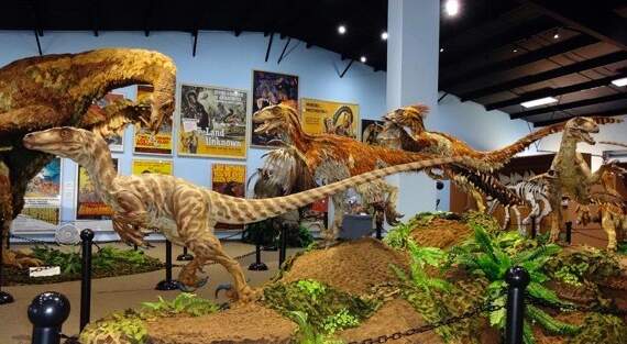 One of the dinosaur exhibits with plants and dinosaur models at the dinosaur museum in Utah